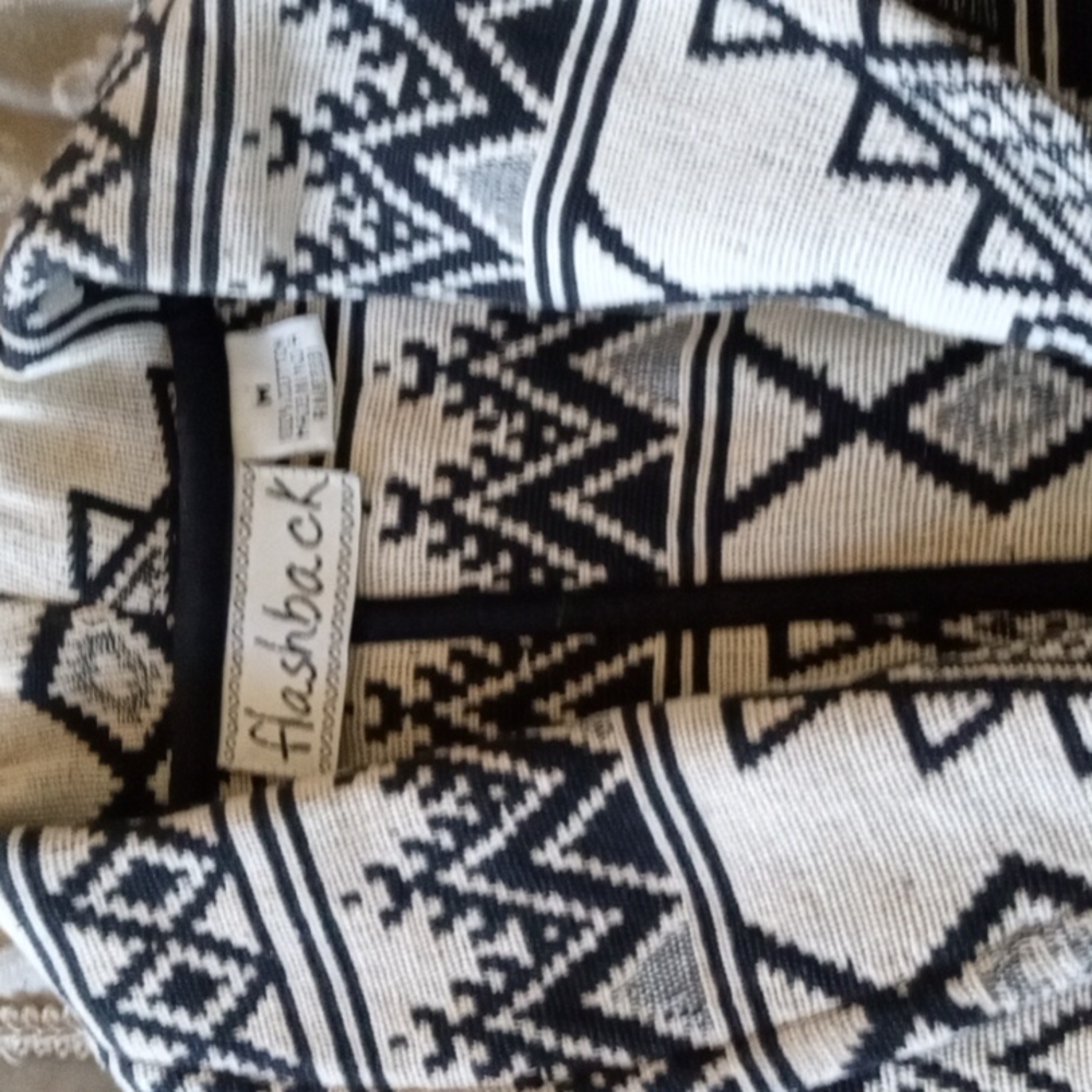 Short bolero type jacket with black print and one button closure. India made.